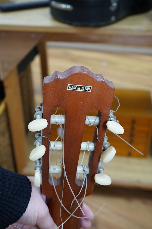 A Suzuki classical guitar, no.3067. Condition - fair, one string missing and scratches to the body.